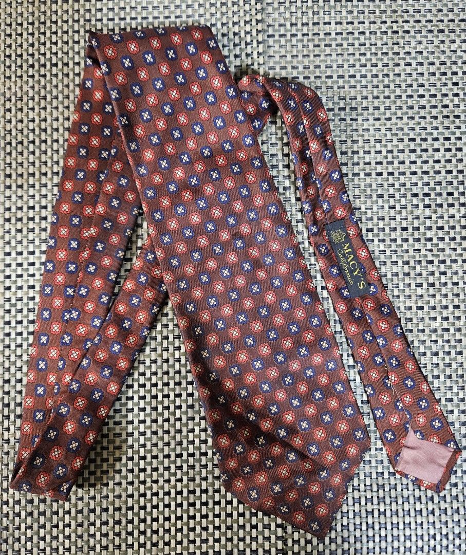 Macy's California Kipper Silk Tie - Red Blue Pattern (Category: Ties) located in Rizal. Submitted by cherry_garcia (Listing ID 1459382265, Image 1). Description: - Classic silk tie from Macy's California - Rich brown background with a repeating red and blue floral-like pattern - Small Kipper brand tag on the back - Ideal for formal events or business casual attire - Adds a stylish pop of color to your look.