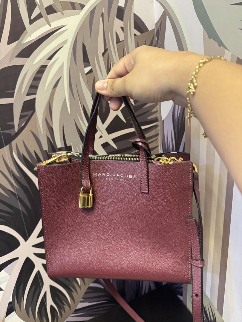 Marc Jacobs Burgundy Leather Lock Tote Bag (Category: Luxury Bags & Wallets) located in Manila. Submitted by abieebey (Listing ID 1459401618, Image 2). Description: - Brand: Marc Jacobs - Color: Burgundy - Material: Leather - Features: Gold lock detail on front, top zipper closure - Includes: Detachable shoulder strap - Interior: Spacious, ideal for essentials - Versatile: Great for everyday use or evening outings.