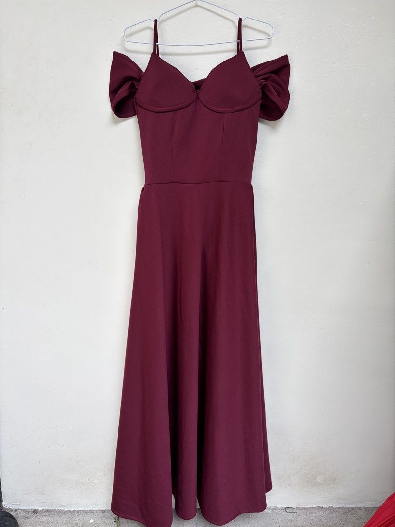 Maroon Off-Shoulder Bridesmaid Dress (Category: Dresses) located in Angono. Submitted by thingsbyzia (Listing ID 1459343625, Image 2). Description: - Deep maroon midi dress - Flattering sweetheart neckline with ruched detailing - Cold shoulder design with trendy puffy sleeves - Delicate spaghetti straps - Convenient back zipper closure - Flattering skater skirt style - Ideal for weddings, events, or special occasions.