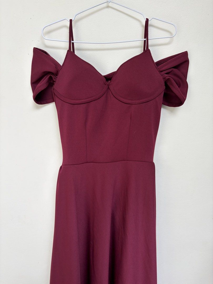 Maroon Off-Shoulder Bridesmaid Dress (Category: Dresses) located in Angono. Submitted by thingsbyzia (Listing ID 1459343625, Image 1). Description: - Deep maroon midi dress - Flattering sweetheart neckline with ruched detailing - Cold shoulder design with trendy puffy sleeves - Delicate spaghetti straps - Convenient back zipper closure - Flattering skater skirt style - Ideal for weddings, events, or special occasions.