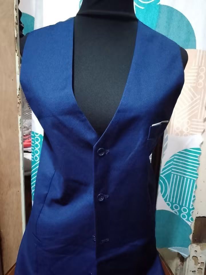 Men's Blue Formal Vest (Category: Vests) located in Batangas. Submitted by sheenx.09 (Listing ID 1459421100, Image 1). Description: - 2xl on tag (XL to 2xl) - Classic blue formal vest 🫶 - Button-up front with three buttons - Left chest pocket 😉 - Smooth satin lining ✅ - Ideal for formal occasions or as part of a suit.