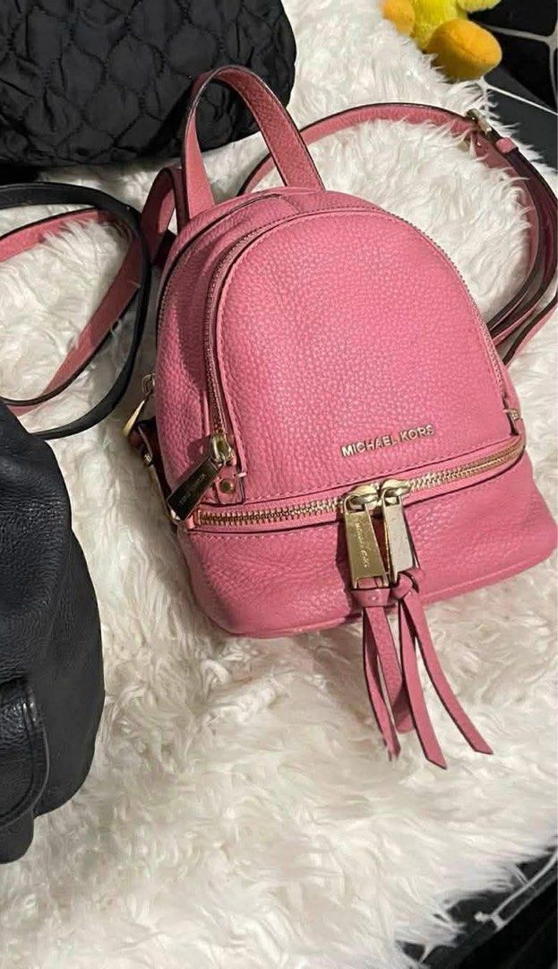 Michael Kors Pink Leather Mini Backpack (Category: Backpacks) located in Davao. Submitted by unabellac (Listing ID 1459444409, Image 3). Description: - Cute pink Michael Kors mini backpack - Made of textured leather - Gold hardware with zipper details - Adjustable straps for comfort - Small top handle - Great for everyday use or a night out - Plenty of space for essentials - A stylish accessory.