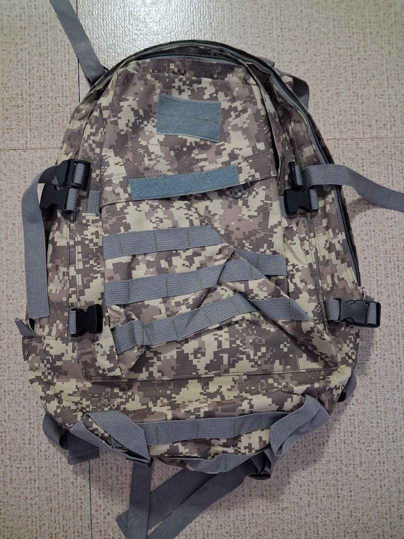 Military camouflage backpack (Category: Backpacks) located in Angeles City. Submitted by anneps (Listing ID 1459477153, Image 1). Description: - Digital camouflage design - Multiple straps and buckles for secure gear attachment - Velcro patches on the front for customization - Plenty of external attachment points - Sturdy zippers - Perfect for outdoor activities, hiking, camping, or travel.