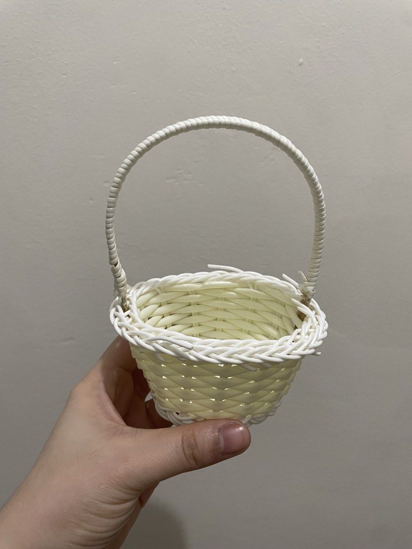 Mini Woven Basket with Handle (Category: Storage Boxes & Baskets) located in Guiguinto. Submitted by beatan13 (Listing ID 1459451599, Image 1). Description: - Adorable woven basket - Features a convenient handle for easy carrying - Stylish white woven exterior - Soft pale yellow interior - Perfect for displaying small decorations or trinkets - Great for DIY craft projects or as charming party favors.