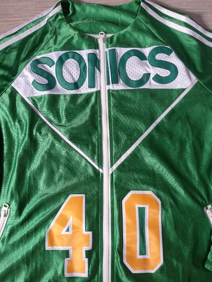 Mitchell & Ness Seattle Sonics Shawn Kemp Jersey Jacket (Category: Coats, Jackets and Outerwear) located in Manila. Submitted by thriftyboyzzz (Listing ID 1459428967, Image 3). Description: - Seattle Sonics Jacket - Features Shawn Kemp's name and number 40 - Mitchell & Ness brand - Color: Green with white and yellow accents - Full zip front with pockets - Elastic cuffs and hem - Ideal for Seattle Sonics and Shawn Kemp fans.