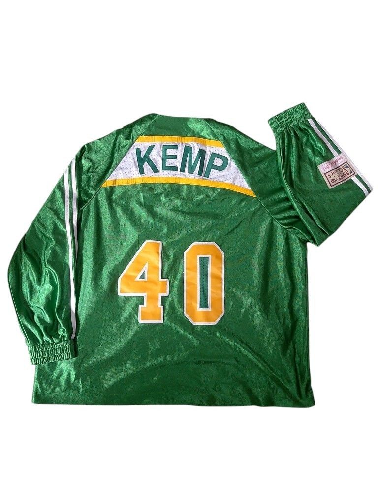 Mitchell & Ness Seattle Sonics Shawn Kemp Jersey Jacket (Category: Coats, Jackets and Outerwear) located in Manila. Submitted by thriftyboyzzz (Listing ID 1459428967, Image 2). Description: - Seattle Sonics Jacket - Features Shawn Kemp's name and number 40 - Mitchell & Ness brand - Color: Green with white and yellow accents - Full zip front with pockets - Elastic cuffs and hem - Ideal for Seattle Sonics and Shawn Kemp fans.