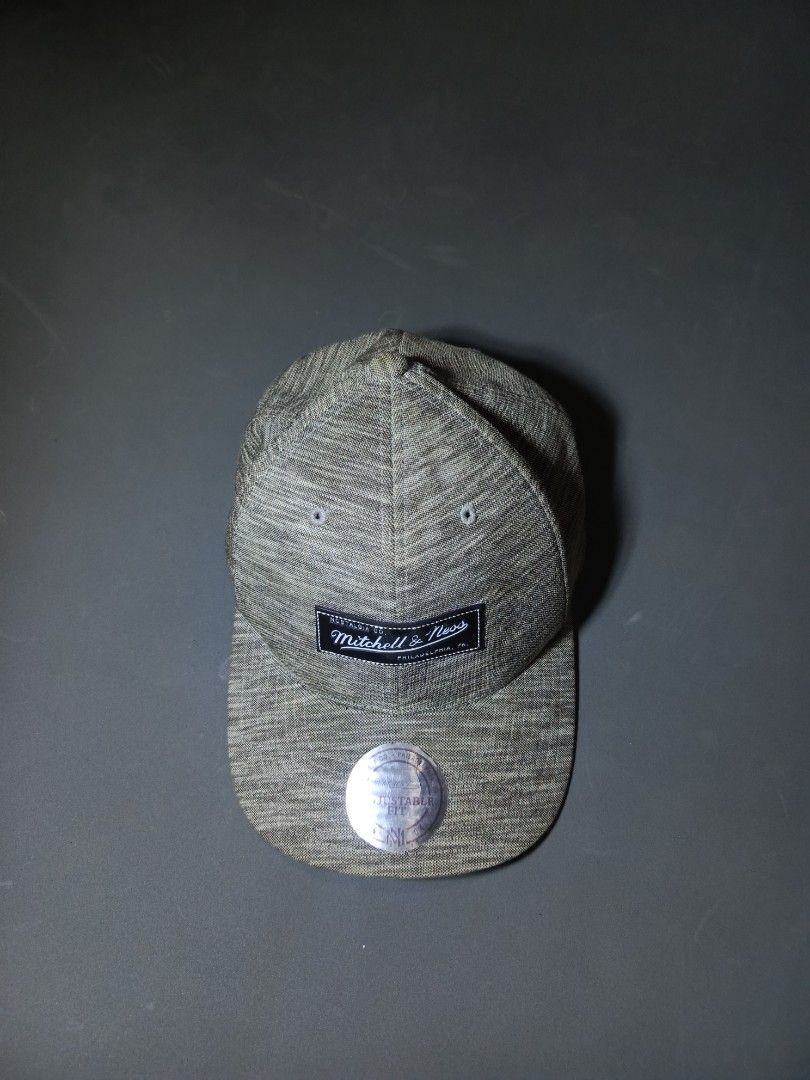 Mitchell & Ness Snapback Cap (Category: Caps & Hats) located in General Santos City (Dadiangas). Submitted by gongskate (Listing ID 1459291350, Image 1). Description: - Mitchell & Ness snapback cap - Grey marl textured fabric - Mitchell & Ness logo patch on front - Embroidered logo on back - Adjustable snap closure for custom fit - Classic baseball cap style.