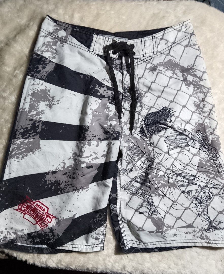 MMA Elite Board Shorts Samurai Design (Category: Shorts) located in Bantayan. Submitted by markjimenez1975557 (Listing ID 1459413075, Image 1). Description: excellent small on tag waist 29-31 length 22 with single ran - Cool MMA Elite board shorts - Features a samurai warrior graphic on one side - Black and white stripe pattern on the other side - Drawstring waist for a secure fit - Ideal for swimming or training sessions.