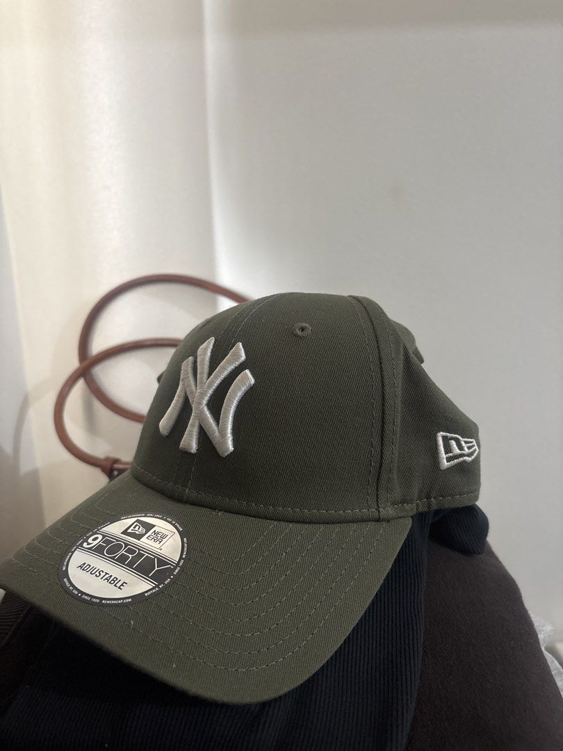 New Era 9FORTY Adjustable Cap - Olive Green (Category: Caps & Hats) located in Manila. Submitted by de.clutterthings (Listing ID 1459324500, Image 1). Description: - Olive green New Era cap - Features classic embroidered NY Yankees logo on the front - 9FORTY model with adjustable strap for a comfortable fit - New Era logo embroidered on the side - Ideal for everyday wear.