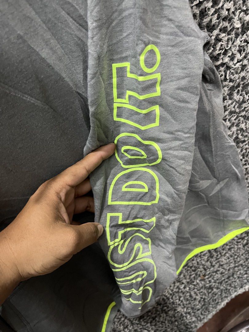 Nike Dri-FIT "Just Do It" Pullover Hoodie | Size XL (Category: Hoodies) located in General Trias. Submitted by zrchustle.604 (Listing ID 1459480825, Image 2). Description: Nike Dri-FIT "Just Do It" Pullover Hoodie in heather charcoal gray featuring vibrant volt / neon green accents. Key Features Design Accents: High-visibility neon green embroidered Nike Swoosh on the left chest, matching trim running along the asymmetrical hemline, and a promine
