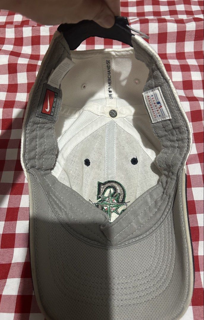 Nike Seattle Mariners MLB Baseball Cap (Category: Caps & Hats) located in Manila. Submitted by ilovebubu28 (Listing ID 1459461471, Image 3). Description: - Seattle Mariners baseball cap - Features the iconic Mariners 'S' logo on the front - Nike 'Team' tag and 'Nike Fit' on the side - MLB Genuine Merchandise tag inside - Classic black and white colorway - A must-have for any Seattle Mariners fan.