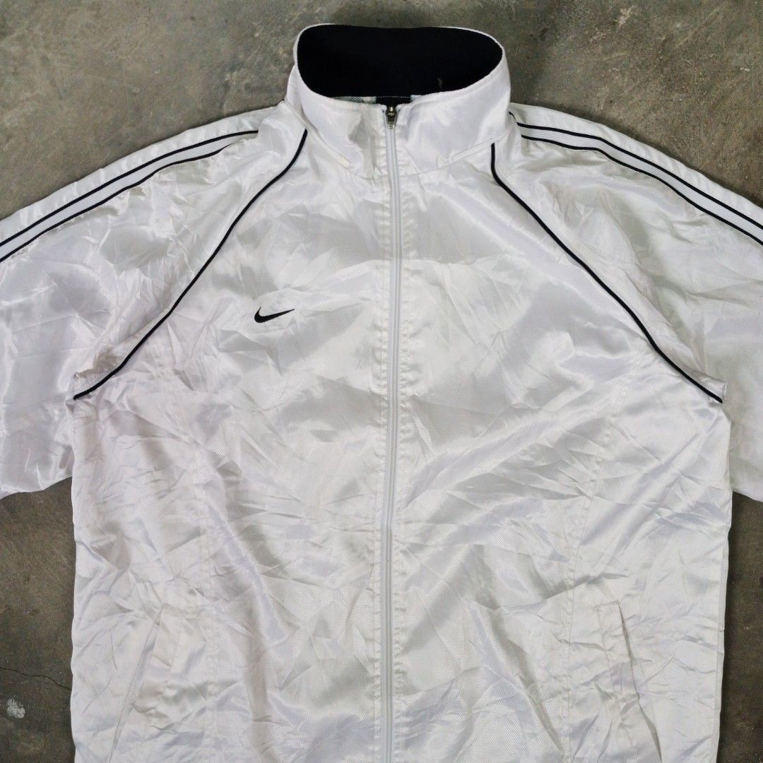 Nike White Track Jacket (Category: Coats, Jackets and Outerwear) located in Manila. Submitted by joefrey12 (Listing ID 1459373062, Image 2). Description: - White Nike track jacket - Large 23x27 - Black piping on sleeves and collar - Full zip closure - Mesh lining inside - Size: Large (L) - Ideal for casual wear or sports activities.