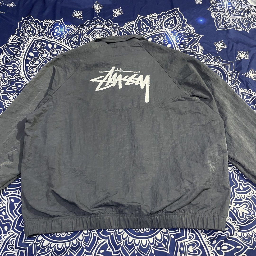 Nike x Stussy reflective Windbreaker Jacket (Category: Coats, Jackets and Outerwear) located in Quezon City. Submitted by vs.thrift444 (Listing ID 1459362884, Image 2). Description: - Grey Nike windbreaker jacket - Features Stussy logo on the back - Quarter zip closure - Elasticated cuffs and hem - Lightweight material, ideal for layering - Suitable for casual wear or light outdoor activities - Size: S see last pic for the reflective pic.