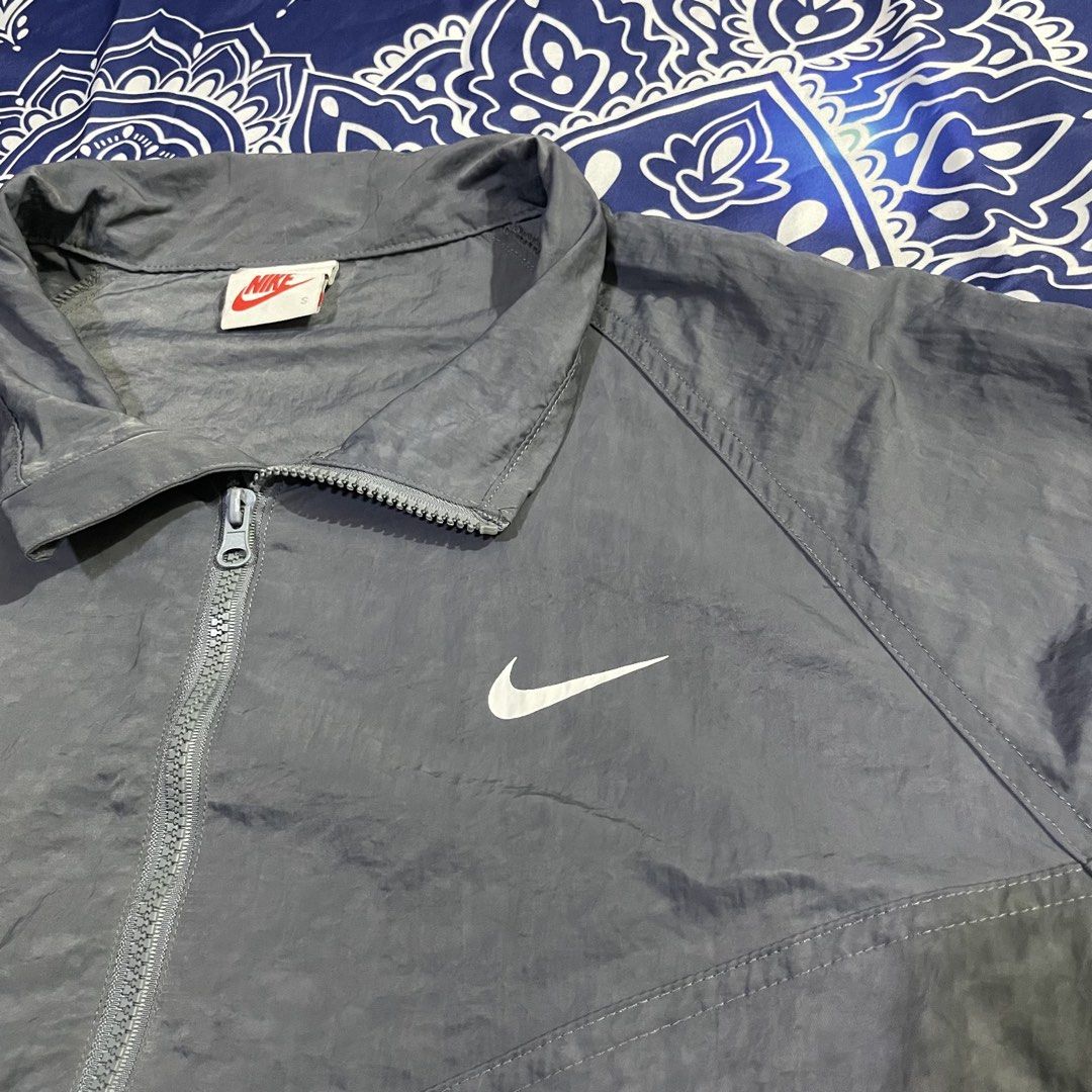 Nike x Stussy reflective Windbreaker Jacket (Category: Coats, Jackets and Outerwear) located in Quezon City. Submitted by vs.thrift444 (Listing ID 1459362884, Image 3). Description: - Grey Nike windbreaker jacket - Features Stussy logo on the back - Quarter zip closure - Elasticated cuffs and hem - Lightweight material, ideal for layering - Suitable for casual wear or light outdoor activities - Size: S see last pic for the reflective pic.