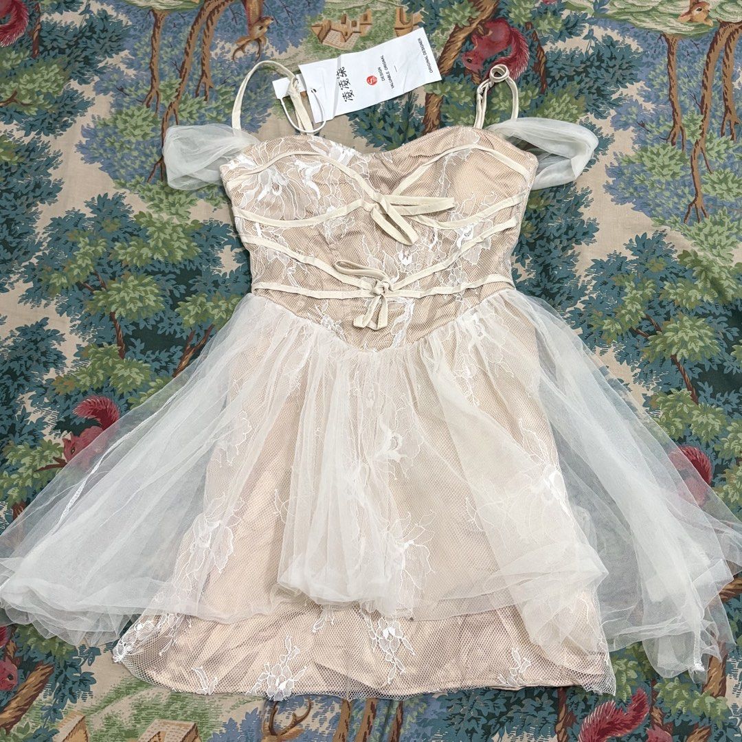 Off-shoulder Tulle Lace Dress (Category: Dresses) located in Pasay City. Submitted by violets.store (Listing ID 1459348251, Image 1). Description: - Cute off-shoulder design - Whimsical tulle overlay skirt featuring lace details - Short, airy puff sleeves made of sheer tulle - Ideal for special occasions or a dreamy, romantic look - Like new with tag still attached - Small size - Las piñas Area .