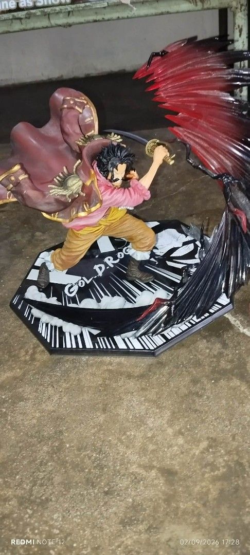 One Piece Gold D. Roger Action Figure (Category: Figurines & Statues) located in Caloocan City. Submitted by iscooo (Listing ID 1459487378, Image 1). Description: - Dynamic Gold D. Roger action figure - Comes with a sword - Features a unique base with piano key design and 'GOLD.D.ROGER' text - Includes red wing-like accessories - Ideal addition to any One Piece fan's collection.