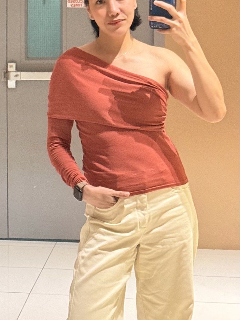 One Shoulder Long Sleeve Top - Rust Color (Category: Blouses) located in Las Pinas. Submitted by shopnshopperph (Listing ID 1459316045, Image 1). Description: - Trendy rust-colored one-shoulder top - Unique design: long sleeve on one side, sleeveless on the other - Stretchy material for a comfortable, flattering fit - Versatile: pairs perfectly with high-waisted pants or skirts - Effortlessly dress up or down for any occasion.