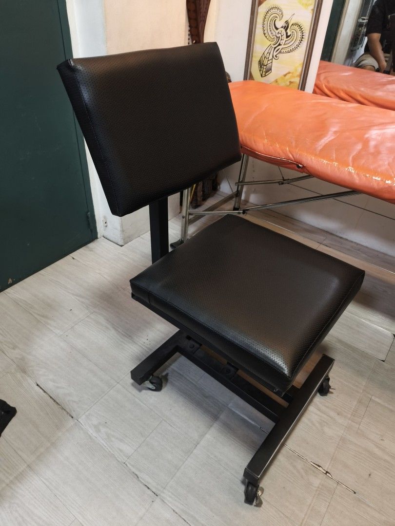 Orange Massage Table with Black Tattoo Chairs (Category: Tables & Sets) located in Pasig City. Submitted by tantan7828659 (Listing ID 1459293395, Image 3). Description: Tattoo bed Tattoo Chair Tattoo Arm Rest Chair with Arm rest - Orange foldable massage table with face cradle hole - Black rolling stool with adjustable height and backrest - Black adjustable tattoo artist chair with armrest and wheels - All items are used and in good working condi