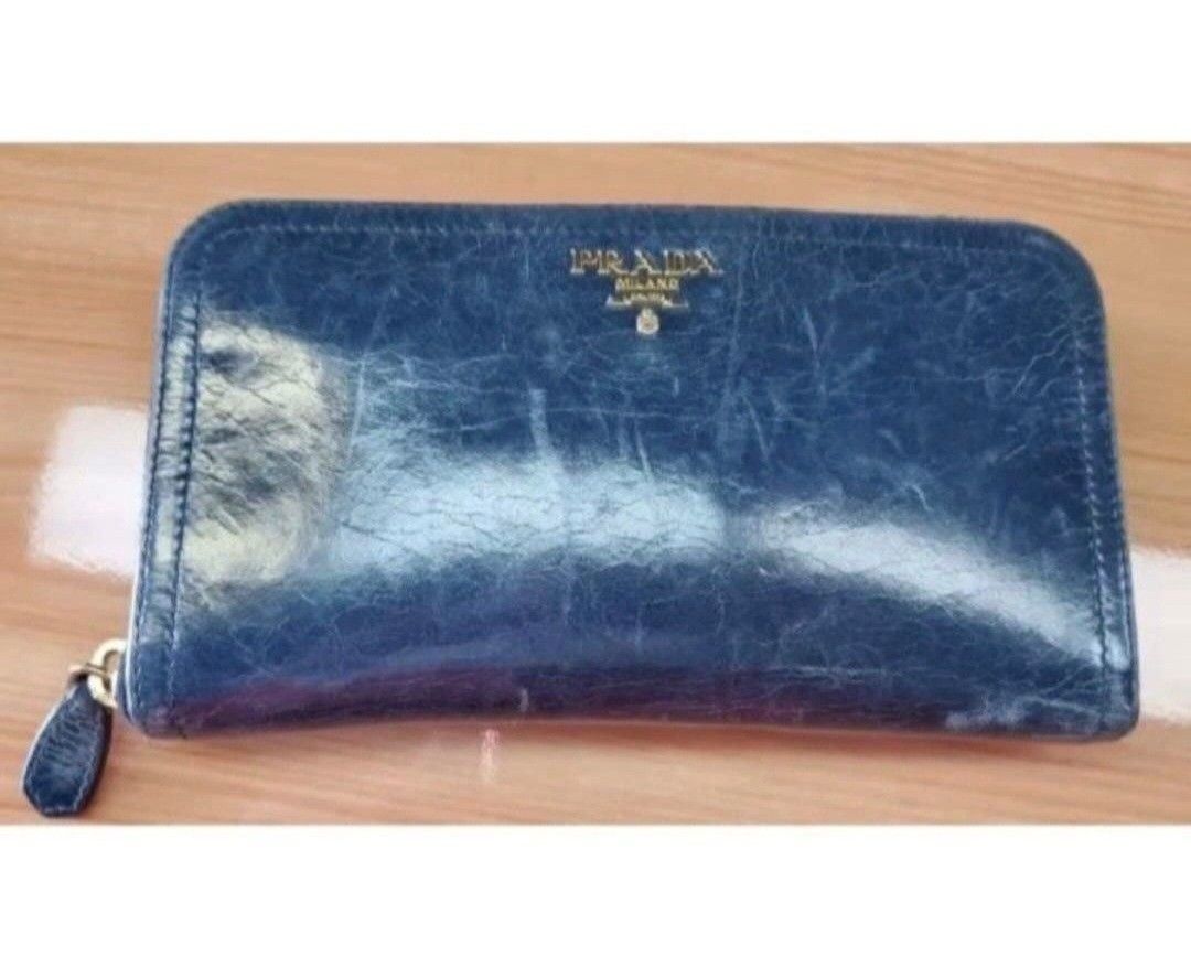PRADA LEATHER ZIP AROUND LONG WALLET, BLUE GREEN (Category: Luxury Bags & Wallets) located in Quezon City. Submitted by stuffiesetc (Listing ID 1459390227, Image 2). Description: PRADA LEATHER ZIP AROUND LONG WALLET, BLUE GREEN Guaranteed Authentic. Used with normal signs of regular use. Some scuffs on the corners and zipper pulls, marks on the inside and coin pocket. No holes or tear. Bought in italy for about Php22,000+. No dust bag or card inc