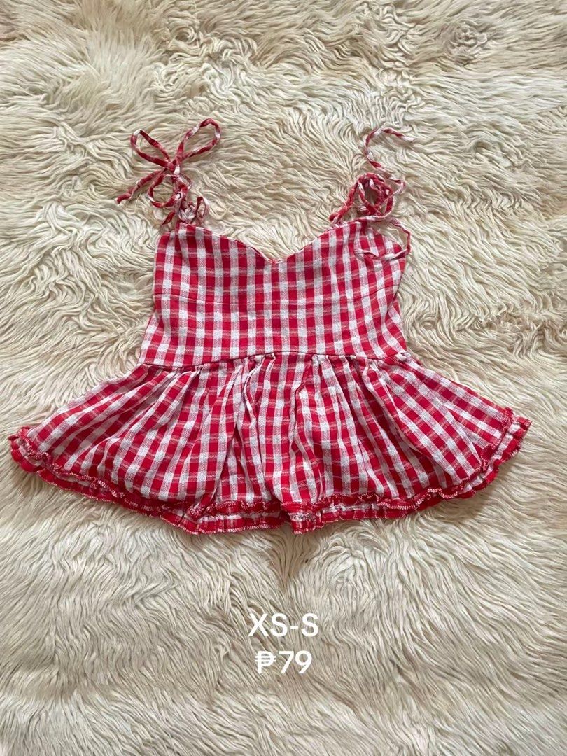 Red and White Gingham Tie-Strap Peplum Top (Category: Sleeveless) located in Manila. Submitted by prelovedsbypink (Listing ID 1459410762, Image 1). Description: - Adorable red and white gingham peplum top - Features adjustable tie straps on the shoulders - Ruffled hem detail for a feminine touch - Ideal for a casual, summery outfit - Fits sizes XS to S.