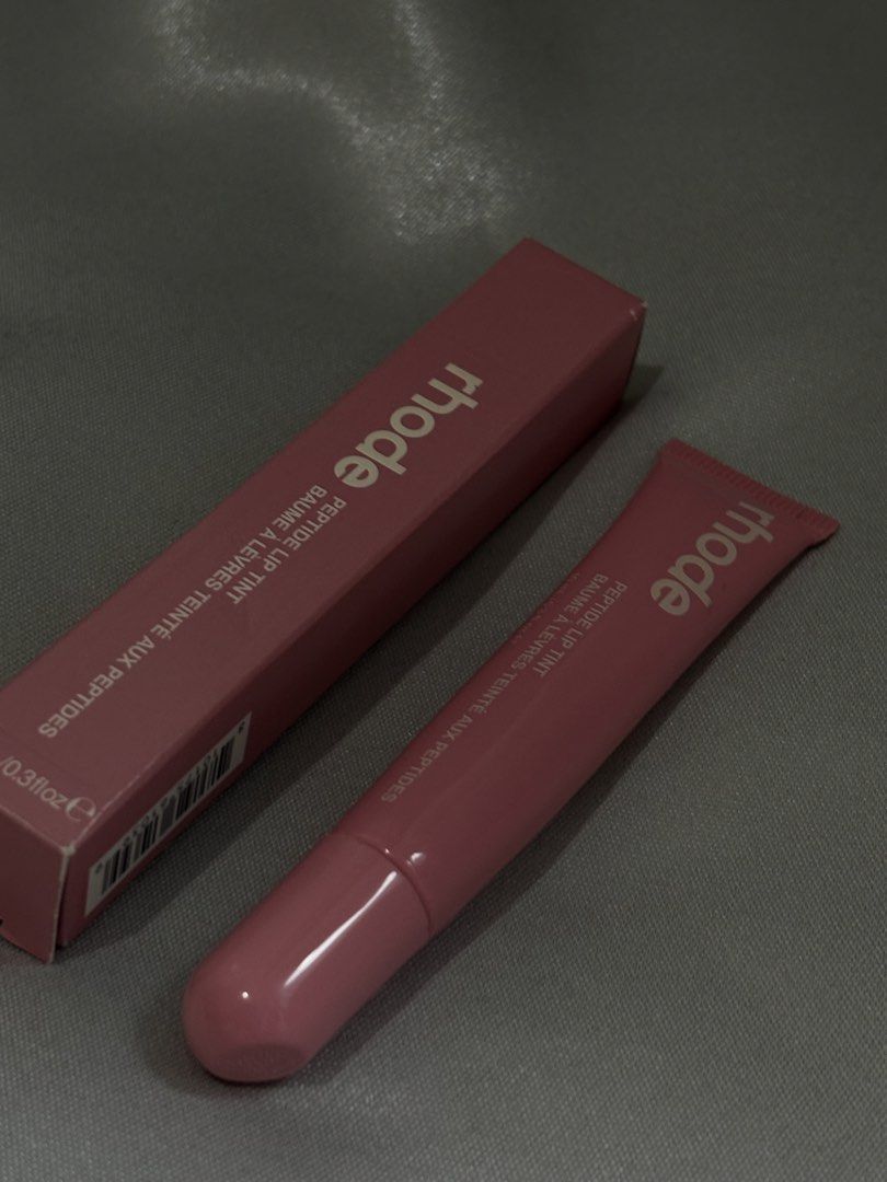 Rhode Peptide Lip Tint Balm (Category: Makeup) located in Apalit. Submitted by randomsellshop (Listing ID 1459487546, Image 1). Description: srp ₱2,099 free shipping for sure buyers lightly used only - Rhode Peptide Lip Tint - Shade: Pink - Key Benefit: Hydrates and tints lips - Includes original box and tube.