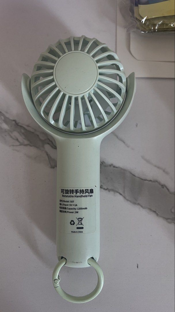 Rotatable Handheld Fan USB Rechargeable Portable Mini Fan (Category: Fans) located in Manila. Submitted by lsqwin2026 (Listing ID 1459329512, Image 2). Description: - Portable handheld fan for on-the-go cooling. - Rotatable design allows for adjustable airflow direction. - USB rechargeable with a long-lasting 1200mAh battery. - 5W power output for efficient cooling. - Comes with a convenient loop for easy carrying. - Made in China..