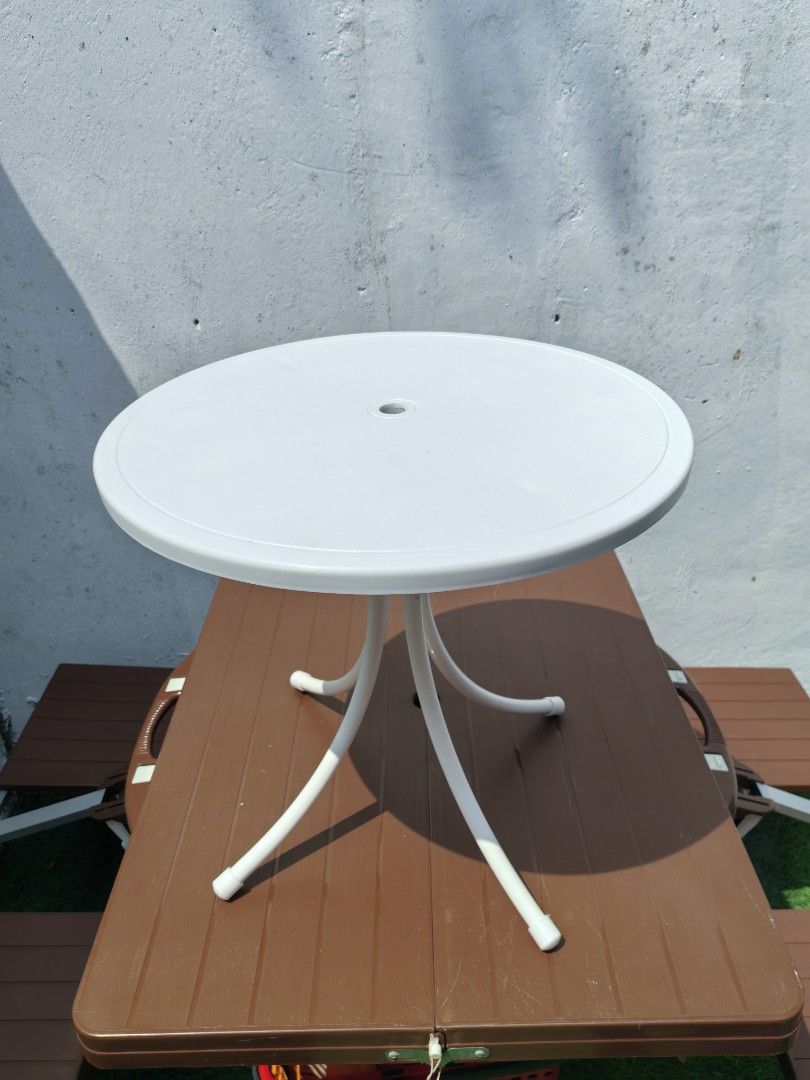 Round Bistro Patio Table (Category: Coffee & Tea Tableware) located in Cebu City. Submitted by dudes_villanueva (Listing ID 1459326422, Image 3). Description: Round Bistro Patio Table 📌 It features a weather-resistant molded plastic tabletop with a central umbrella hole and is supported by four curved metal legs reinforced by a central stabilizing column.Key 📌 Lightweight, all-weather polypropylene resin. 📌 Circular top with an umbrella plug, 