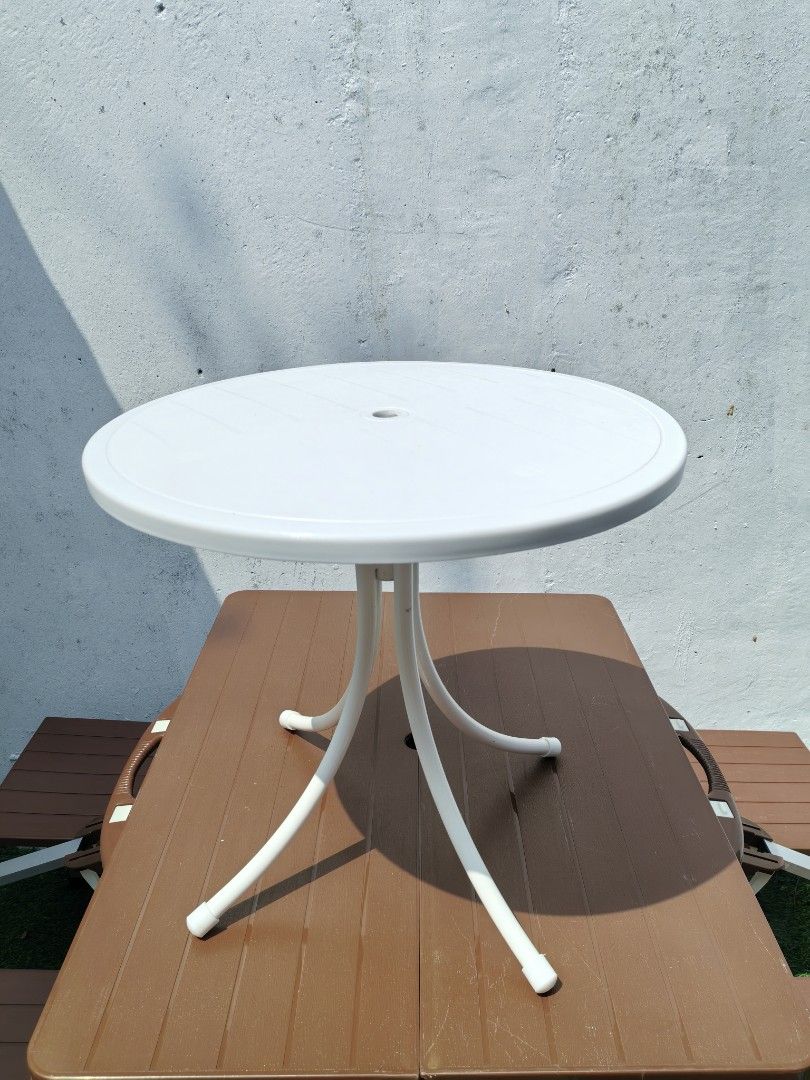 Round Bistro Patio Table (Category: Coffee & Tea Tableware) located in Cebu City. Submitted by dudes_villanueva (Listing ID 1459326422, Image 2). Description: Round Bistro Patio Table 📌 It features a weather-resistant molded plastic tabletop with a central umbrella hole and is supported by four curved metal legs reinforced by a central stabilizing column.Key 📌 Lightweight, all-weather polypropylene resin. 📌 Circular top with an umbrella plug, 