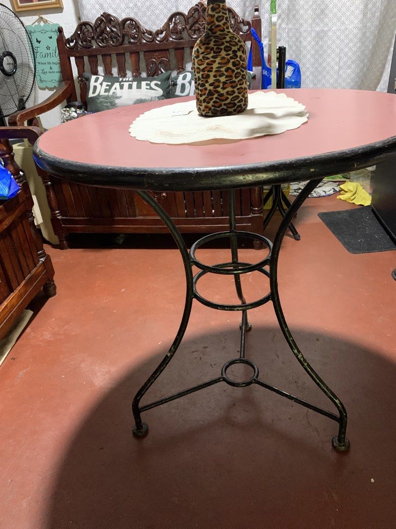 Round Red Table with Black Metal Base (Category: Tables & Sets) located in Caloocan City. Submitted by cindy_01_1075 (Listing ID 1459412437, Image 1). Description: - Round table with a vibrant red top - Sturdy black metal base with a decorative criss-cross design - Ideal size for a small dining area or as a versatile side table - Shows minor wear on the metal base, adding character - Ready to find its new home!.
