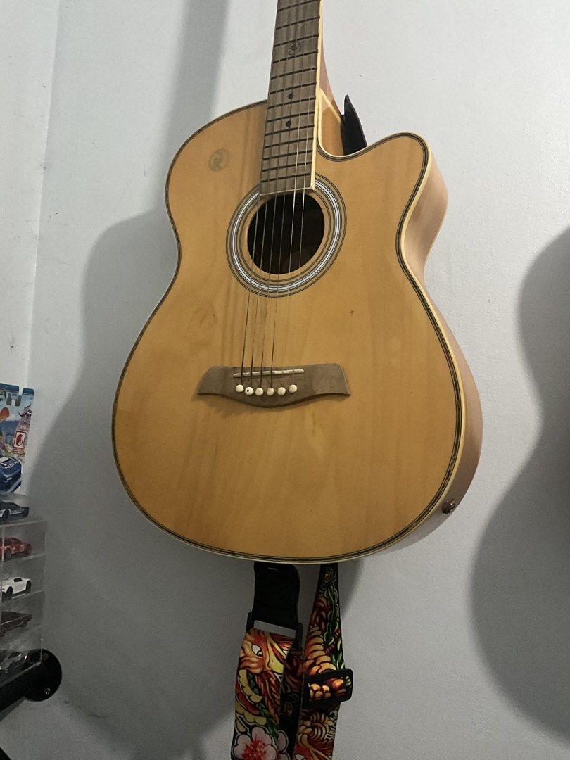 RUSH! RJ Acoustic Guitar with Strap (Category: Musical Instruments) located in Manila. Submitted by djiiie (Listing ID 1459460786, Image 1). Description: - pwede meet up near ever gotesco commonwealth qc. ever sat lang Natural wood finish acoustic guitar - Cutaway body style for easier access to higher frets - Comes with a unique dragon-themed guitar strap - Perfect for beginners or as a new instrument - Ready to play right out of the box.