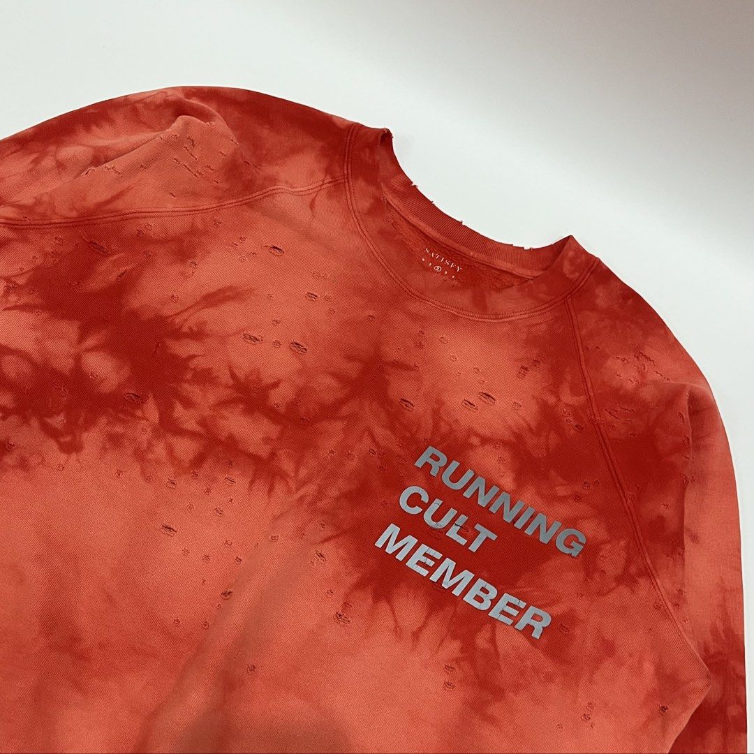 SATISFY - CULT MOTH EATEN CREW SWEATSHIRT (Category: Hoodies) located in Lucena. Submitted by southsidekartell (Listing ID 1459292357, Image 3). Description: Long sleeve cotton fleece sweatshirt in bleach red. Distressing and fading throughout. Rib knit crewneck collar, cuffs, and hem. Text printed in reflective silver-tone at chest. Detachable tag at hem. Concealed pocket at interior hem. Tonal stitching. SIZE 2 FITS MEDIUM NO MAJOR ISSUES COLOR