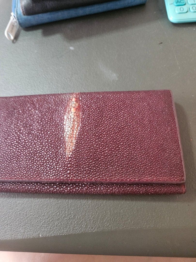 Sea Star Stingray Leather Wallet (Category: Wallets & Card holders) located in Manila. Submitted by hausofgadgetatbp (Listing ID 1459347531, Image 1). Description: - Genuine burgundy stingray leather wallet - Unique, textured stingray skin - Secure snap closure - Multiple card slots for easy organization - Interior zippered compartment for added security - Perfect for keeping your essentials tidy.