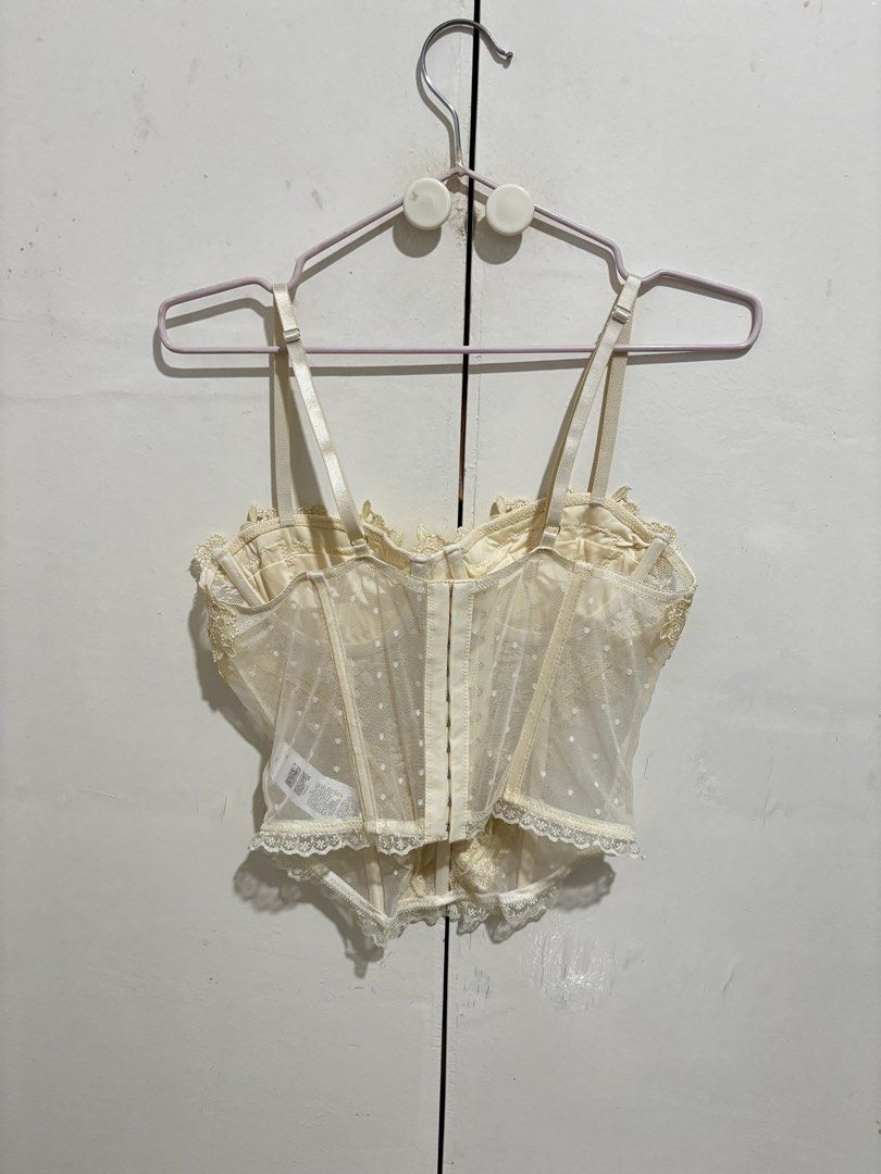 SHEIN Cream Lace Corset Top (Category: Sleeveless) located in Manila. Submitted by dianafayesimbre (Listing ID 1459361313, Image 2). Description: - Sheer lace corset top - Features delicate floral appliques - Adjustable straps for a perfect fit - Front hook-and-eye closure for easy wear - Scalloped lace trim along hem and neckline - Cute dotted pattern on sheer fabric - Versatile for layering or wearing solo - Size XS on tag but can fit up to sem