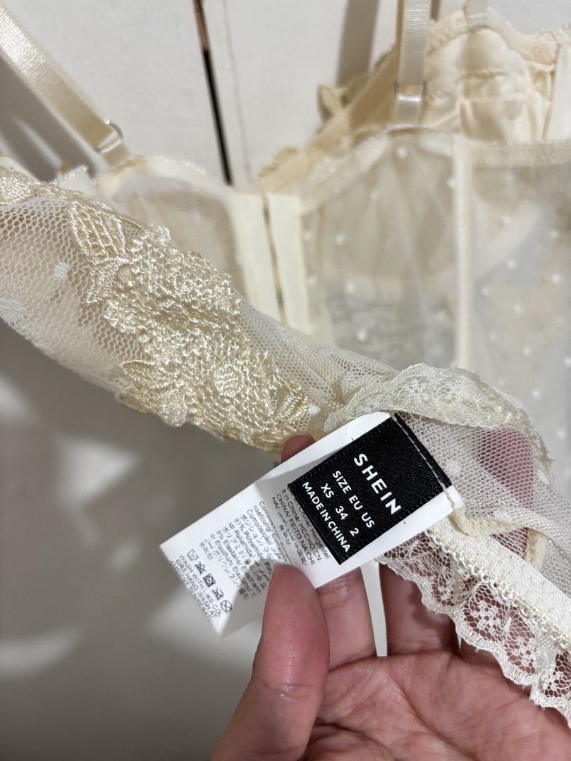 SHEIN Cream Lace Corset Top (Category: Sleeveless) located in Manila. Submitted by dianafayesimbre (Listing ID 1459361313, Image 3). Description: - Sheer lace corset top - Features delicate floral appliques - Adjustable straps for a perfect fit - Front hook-and-eye closure for easy wear - Scalloped lace trim along hem and neckline - Cute dotted pattern on sheer fabric - Versatile for layering or wearing solo - Size XS on tag but can fit up to sem