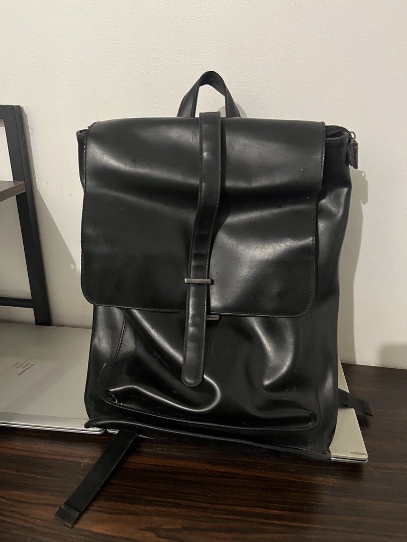 Shigetsu Black Faux Leather Backpack (Category: Backpacks) located in Manila. Submitted by cartmarj (Listing ID 1459383511, Image 1). Description: - Chic black faux leather backpack - Secure flap closure with buckle strap - Main compartment with zip closure - Comfortable padded shoulder straps - Breathable mesh paneling on the back - Ideal for everyday adventures or travel - May onting rust but I think removable naman. .