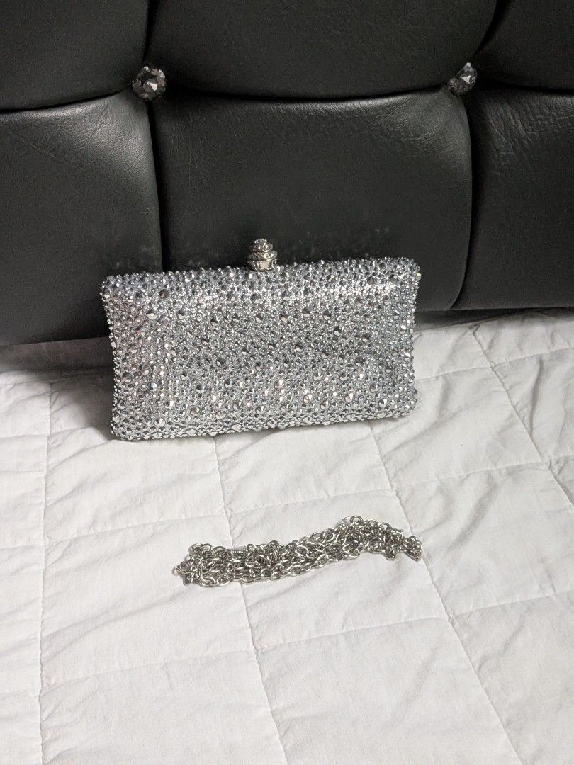 Silver Crystal Rhinestones Clutch Bag (Category: Clutches) located in Quezon City. Submitted by nnncorner (Listing ID 1459394556, Image 3). Description: Silver Gray Crystal Rhinestones 2 Way Evening Clutch Bag can be used as hand carry or sling bag can fit phone ,lipstick, etc no missing rhinestones still with packaging it sparkles in light new and never been used 1,890.