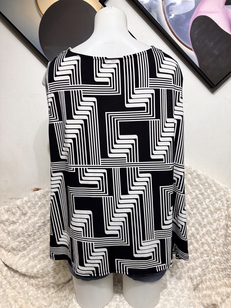 Sleeveless Cowl Neck Geometric Print Top (Category: Sleeveless) located in Marikina City. Submitted by lorradel (Listing ID 1459424973, Image 3). Description: - Sleeveless top in classic black and white. - Features a striking geometric print. - Elegant cowl neck design. - Versatile: dress up or down. - Comfortable and stylish. - Pairs perfectly with jeans or skirts. - MAY HAVE some washable stains (hindi maiiwasan) needs washing; had been stored 