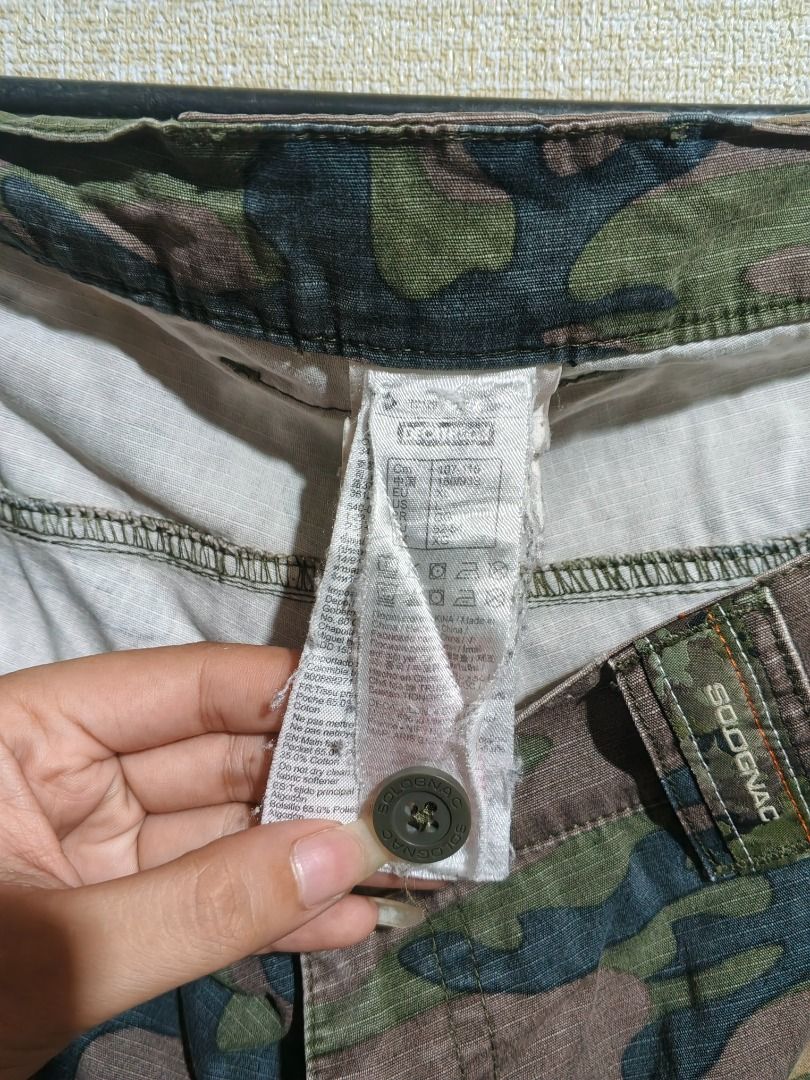 Sodignac Camouflage Cargo Shorts (Category: Shorts) located in Caloocan City. Submitted by nebs_seller (Listing ID 1459442224, Image 3). Description: - Cool camo cargo shorts by Sodignac - Plenty of pockets for all your essentials - Comfortable elastic waistband - Perfect for casual wear or outdoor adventures - Features a unique orange zip detail on one pocket - In good, pre-loved condition and ready for a new home.