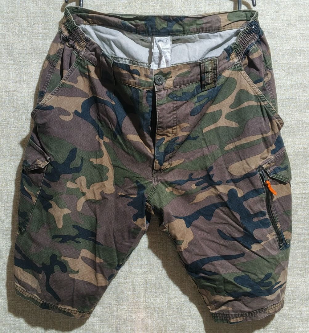 Sodignac Camouflage Cargo Shorts (Category: Shorts) located in Caloocan City. Submitted by nebs_seller (Listing ID 1459442224, Image 1). Description: - Cool camo cargo shorts by Sodignac - Plenty of pockets for all your essentials - Comfortable elastic waistband - Perfect for casual wear or outdoor adventures - Features a unique orange zip detail on one pocket - In good, pre-loved condition and ready for a new home.