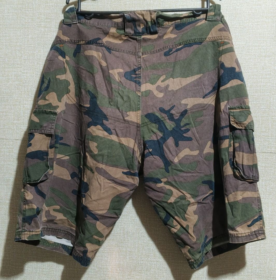 Sodignac Camouflage Cargo Shorts (Category: Shorts) located in Caloocan City. Submitted by nebs_seller (Listing ID 1459442224, Image 2). Description: - Cool camo cargo shorts by Sodignac - Plenty of pockets for all your essentials - Comfortable elastic waistband - Perfect for casual wear or outdoor adventures - Features a unique orange zip detail on one pocket - In good, pre-loved condition and ready for a new home.