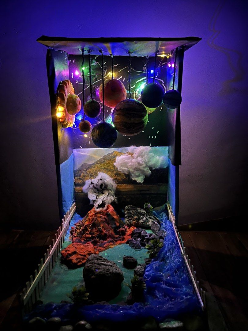 Solar System and Volcano Diorama with Lights (Category: Figurines & Statues) located in Manila. Submitted by kofieematch (Listing ID 1459454809, Image 2). Description: - Handmade diorama featuring a solar system and a volcano scene. - Planets hang with lights. - Volcano erupts with realistic smoke and lava effects. - Includes a river and plants at the bottom. - Ideal for school projects or as a unique display piece..