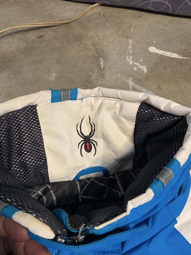 Spyder Ski Jacket Blue White (Category: Coats, Jackets and Outerwear) located in Manila. Submitted by armamentoj94205 (Listing ID 1459340149, Image 2). Description: - Blue and white Spyder ski jacket - Features Spyder logo on chest and spider logo on sleeve/inside - Attached hood for extra warmth and protection - Numerous pockets and zippers for ample storage and convenience - Perfect for your next ski trip!.