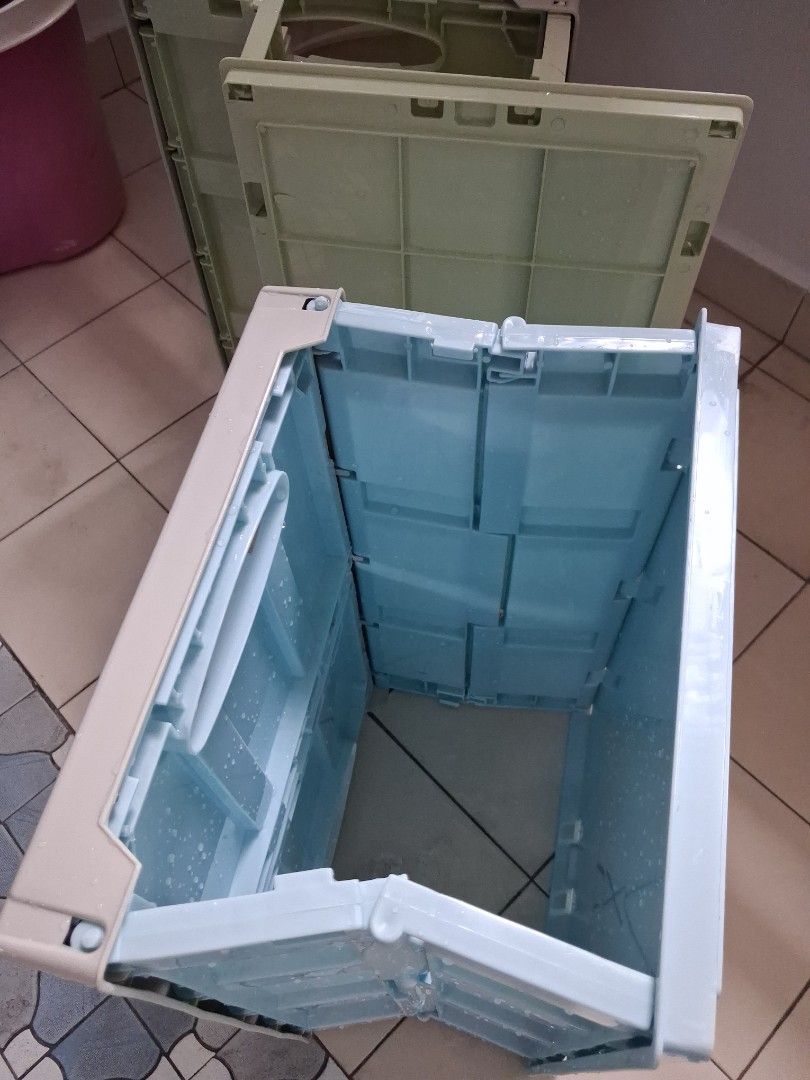 Stackable Storage Boxes with Lids (Category: Storage Boxes & Baskets) located in Singapore. Submitted by mauwonglin13 (Listing ID 1459337315, Image 3). Description: - Set of 2 stackable storage boxes - Colors: Light Green and Light Blue - Features hinged lids for easy access - Blue box includes internal dividers for organization - Foldable design for convenient storage when not in use - Perfect for organizing toys, clothes, and various household 
