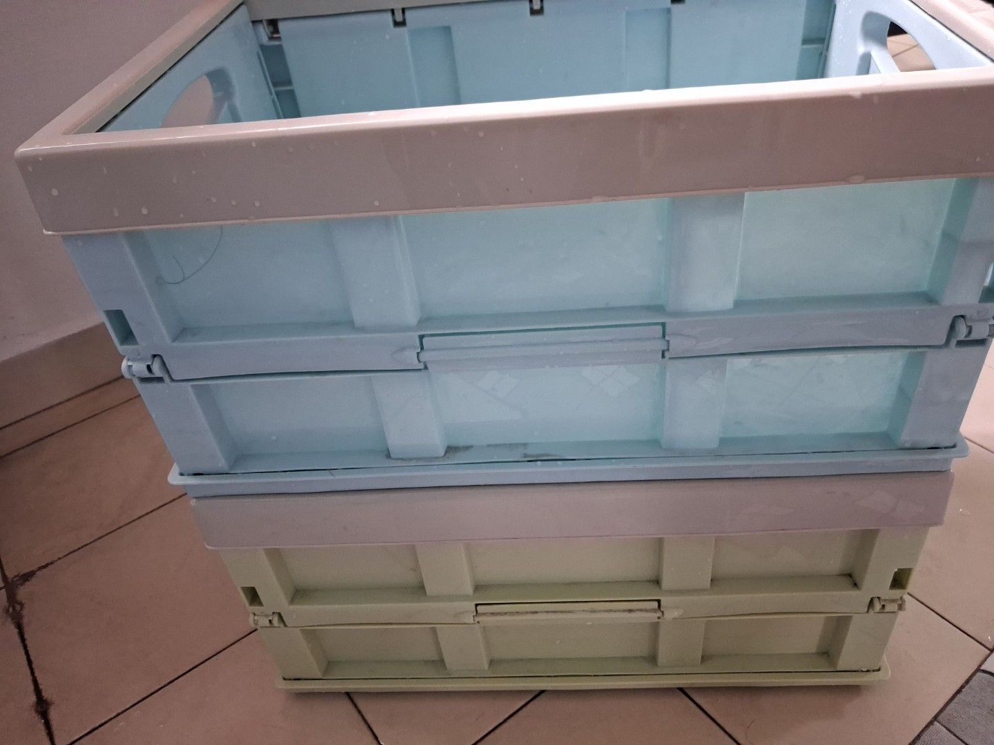 Stackable Storage Boxes with Lids (Category: Storage Boxes & Baskets) located in Singapore. Submitted by mauwonglin13 (Listing ID 1459337315, Image 1). Description: - Set of 2 stackable storage boxes - Colors: Light Green and Light Blue - Features hinged lids for easy access - Blue box includes internal dividers for organization - Foldable design for convenient storage when not in use - Perfect for organizing toys, clothes, and various household 