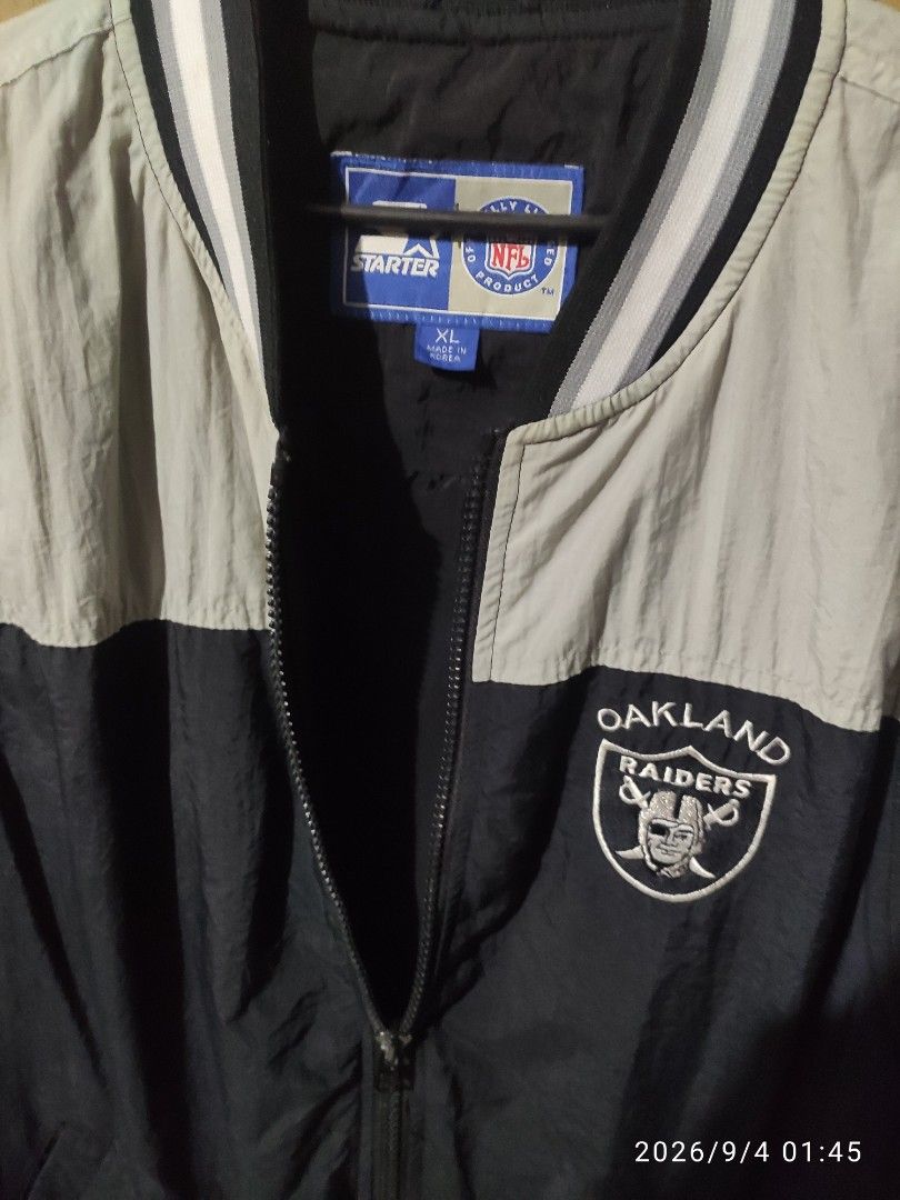 Starter Oakland Raiders NFL Jacket XL (Category: Coats, Jackets and Outerwear) located in Las Pinas. Submitted by vtg_sakalam2021 (Listing ID 1459465002, Image 3). Description: - Authentic Oakland Raiders Starter Jacket - Size: XL - Stylish black and beige color block design - Official NFL merchandise - Features zipper closure with snap button collar - Iconic Starter logo prominently displayed on the back - Made in Korea.