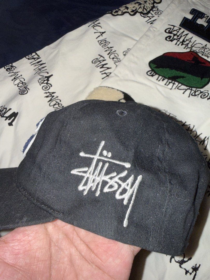 Stussy Black Cap with S Logo (Category: Caps & Hats) located in Manila. Submitted by 35thcollections (Listing ID 1459333649, Image 2). Description: - Classic black Stussy cap - Features a prominent blue 'S' logo on the front - Stussy logo embroidered on the back - Adjustable strap for a comfortable and secure fit - Ideal for everyday casual wear.