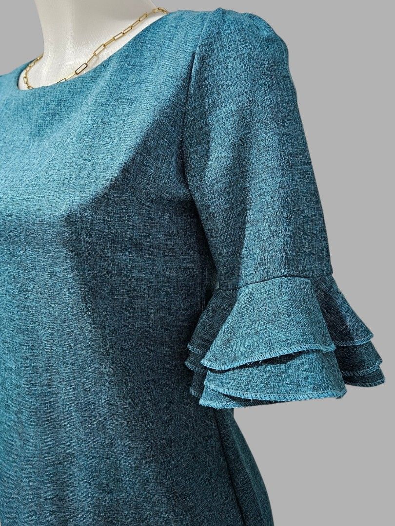 Teal Textured Dress with Ruffle Sleeves (Category: Dresses) located in Quezon City. Submitted by kirstenbella (Listing ID 1459443621, Image 3). Description: - Teal textured dress - Ruffle details on sleeves - Zipper closure at the back - Size: Medium - Like new condition .