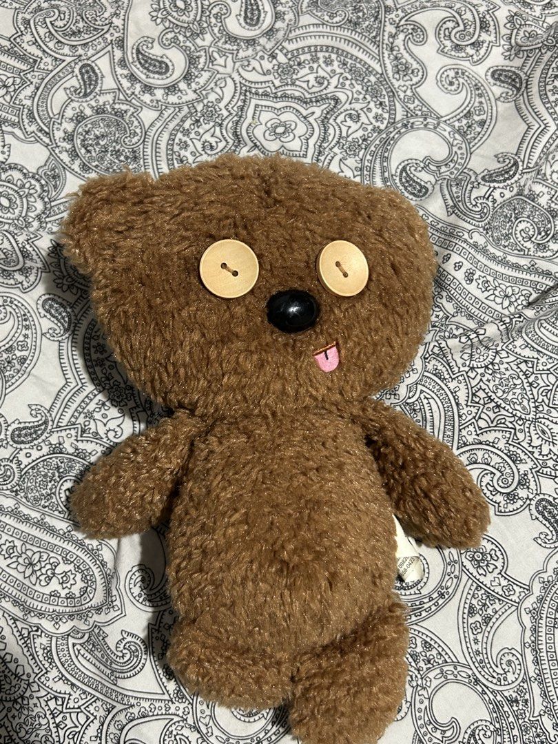 Minions Tim Teddy Bear (Despicable Me) (Category: Plushies & Soft Toys) located in Manila. Submitted by valenpieces (Listing ID 1459364436, Image 1). Description: - Adorable brown teddy bear plush toy. - Features soft, fuzzy fur. - Has two large, charming wooden button eyes. - A cute little pink tongue peeks out. - Ideal for cuddling or as a unique decorative item..