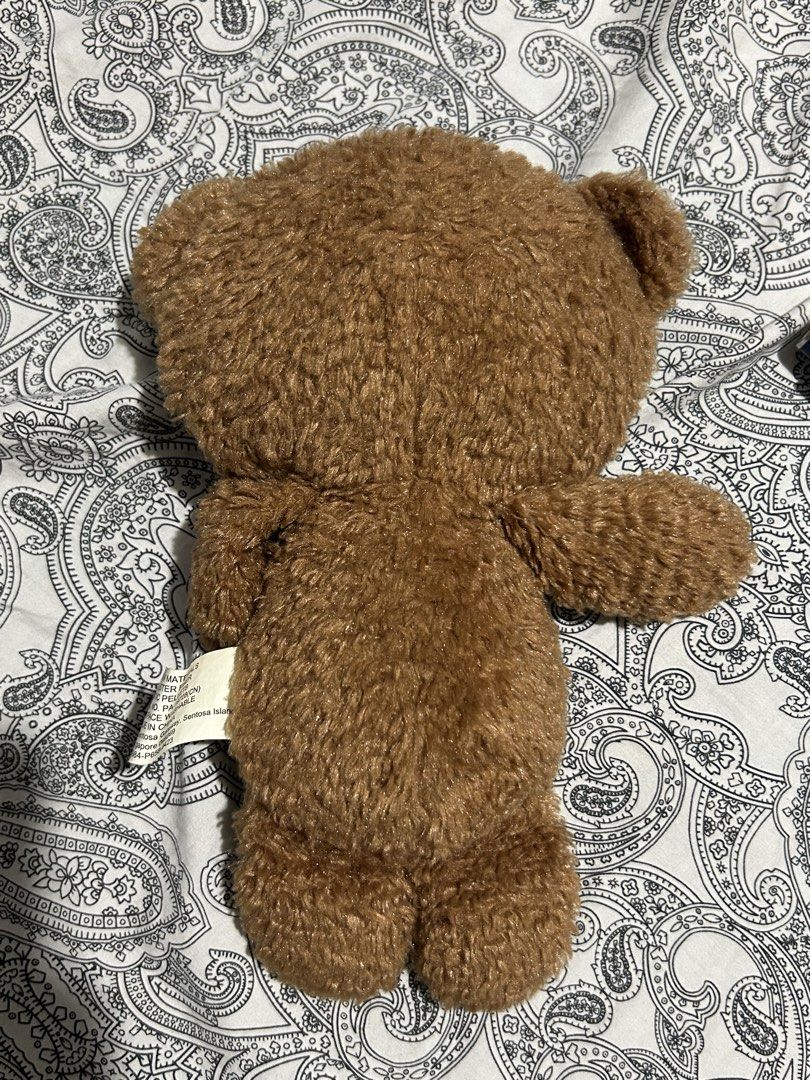 Minions Tim Teddy Bear (Despicable Me) (Category: Plushies & Soft Toys) located in Manila. Submitted by valenpieces (Listing ID 1459364436, Image 2). Description: - Adorable brown teddy bear plush toy. - Features soft, fuzzy fur. - Has two large, charming wooden button eyes. - A cute little pink tongue peeks out. - Ideal for cuddling or as a unique decorative item..