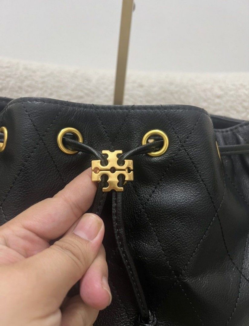 Tory Burch Charlie Drawstring Bag Black (Category: Luxury Bags & Wallets) located in Manila. Submitted by glendamae16 (Listing ID 1459320635, Image 2). Description: - Authentic Tory Burch black leather bucket bag - Elegant diamond quilting all over - Chic gold chain strap - Secure drawstring closure - Convenient side pockets - Comes with original dust bag - Includes an extra strap for versatility - Ideal for everyday style and practicality.